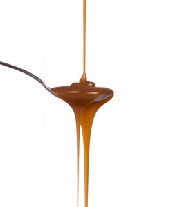 caramel dripping into and out of a spoon