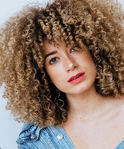 Here Are 5 Ways To Style Your Curly Bangs For The Summer