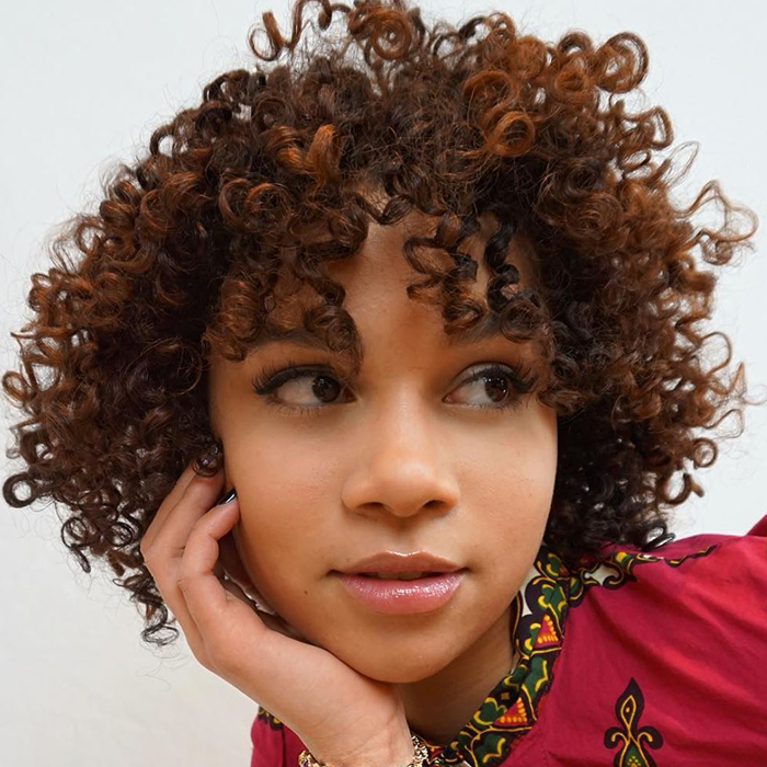 How to Cut and Style Curly Bangs According to a Stylist